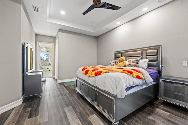 bedroom with visible vents, baseboards, recessed lighting, wood finished floors, and a raised ceiling