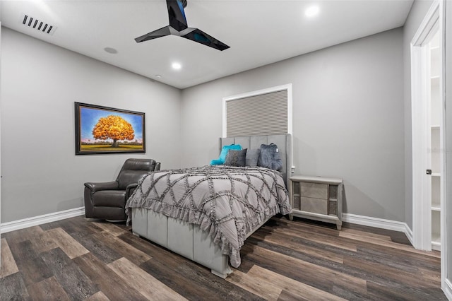 bedroom featuring ceiling fan, wood finished floors, visible vents, and baseboards