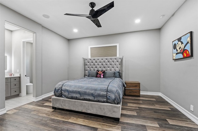 bedroom with recessed lighting, connected bathroom, baseboards, and wood finished floors