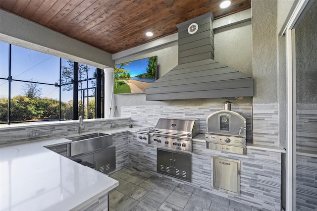 view of patio with a sink, a grill, and exterior kitchen