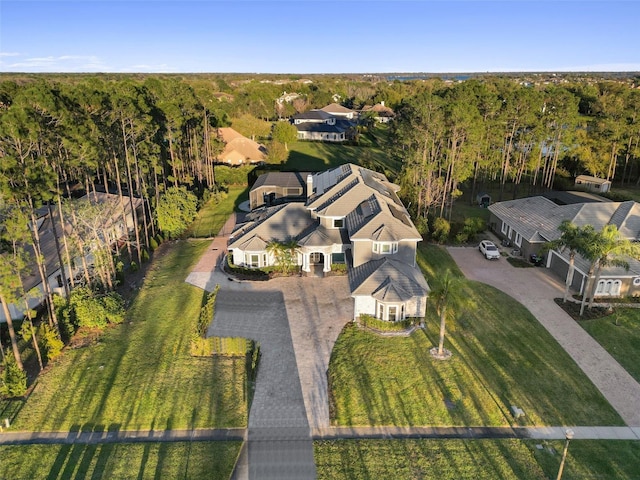 birds eye view of property with a wooded view