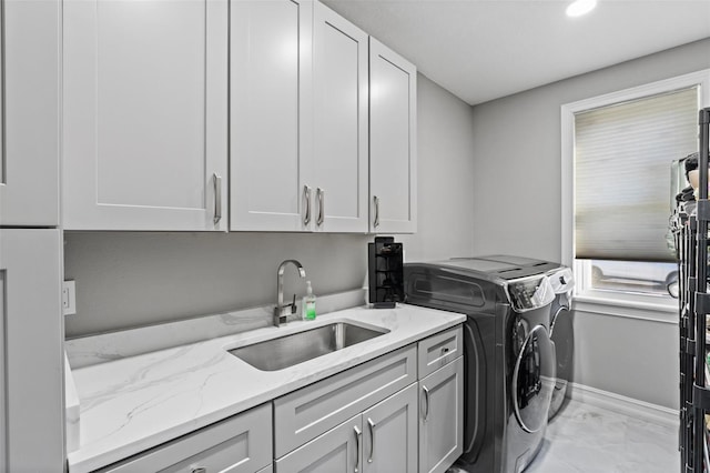 4205 Clarice Ct, Windermere, FL 34786 - washroom with a sink, baseboards, marble finish floor, cabinet space, and washer and dryer