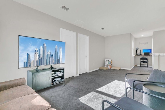 carpeted living area featuring visible vents and baseboards