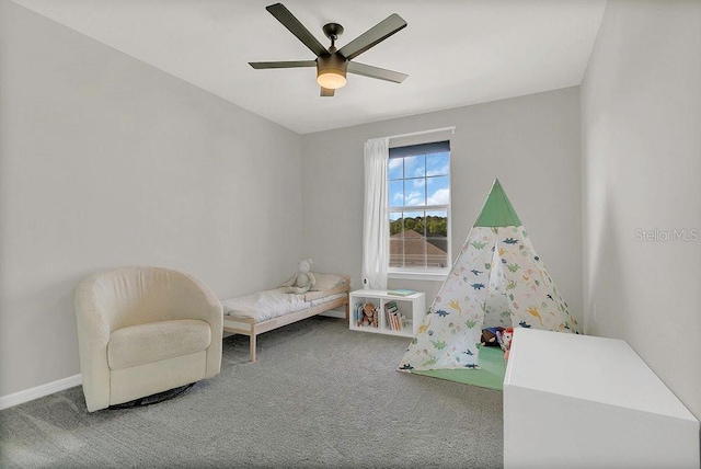 carpeted bedroom with ceiling fan and baseboards