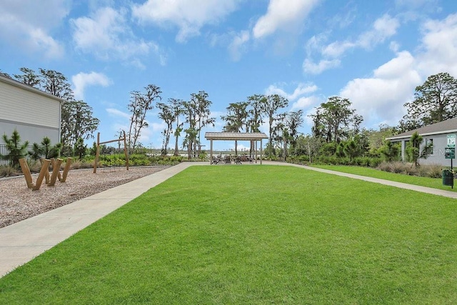 view of property's community with a pergola and a yard