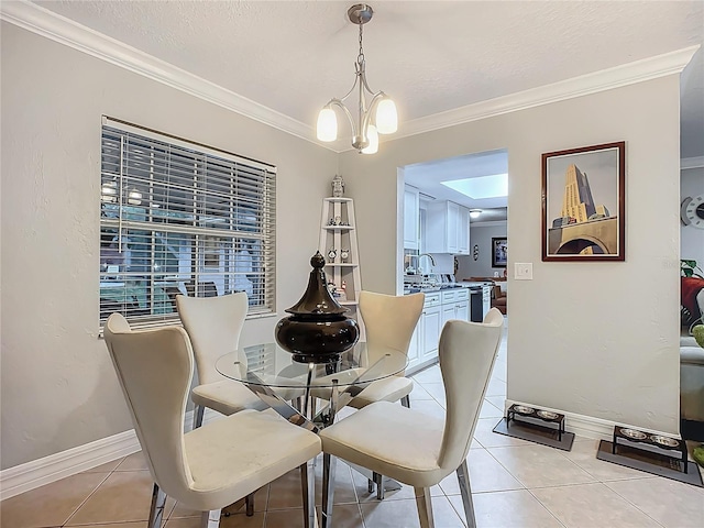 dining room with light tile patterned floors, baseboards, a chandelier, and crown molding