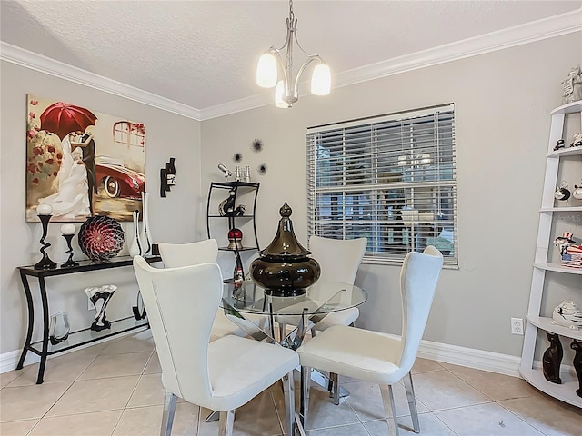 dining room featuring a notable chandelier, ornamental molding, a textured ceiling, light tile patterned flooring, and baseboards