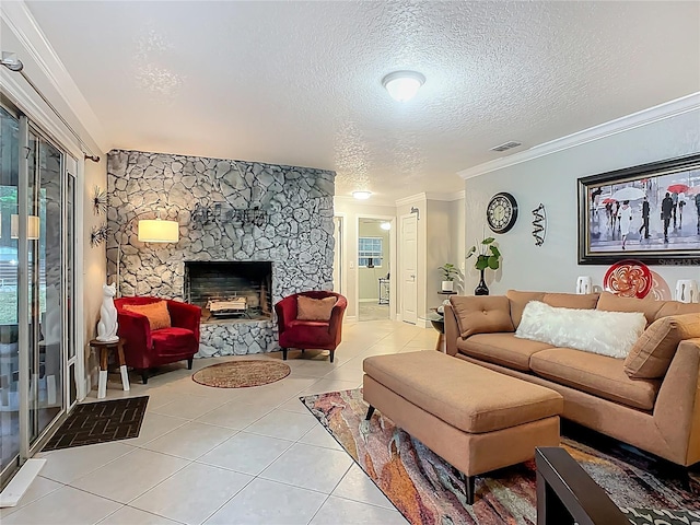 living room with visible vents, crown molding, light tile patterned floors, a fireplace, and a textured ceiling