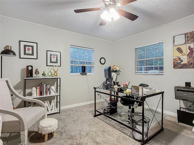 office area featuring baseboards, a textured ceiling, carpet floors, and ceiling fan