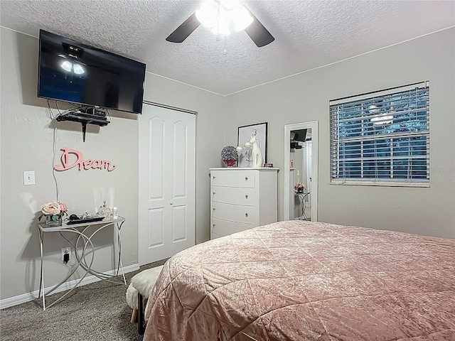 carpeted bedroom featuring a closet, ceiling fan, a textured ceiling, and baseboards