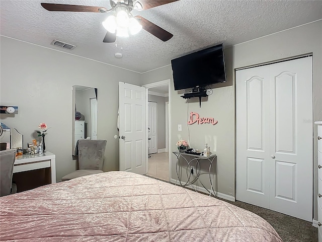 bedroom with visible vents, a textured ceiling, a closet, and a ceiling fan