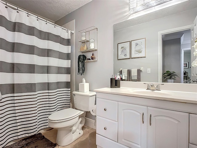 bathroom featuring tile patterned flooring, toilet, a shower with shower curtain, vanity, and a textured ceiling