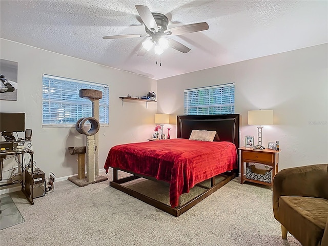 bedroom with baseboards, carpet floors, a textured ceiling, and ceiling fan