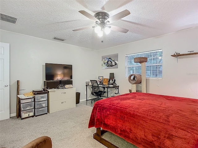 bedroom with visible vents, carpet floors, a textured ceiling, and ceiling fan