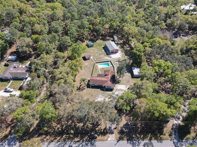 drone / aerial view with a wooded view