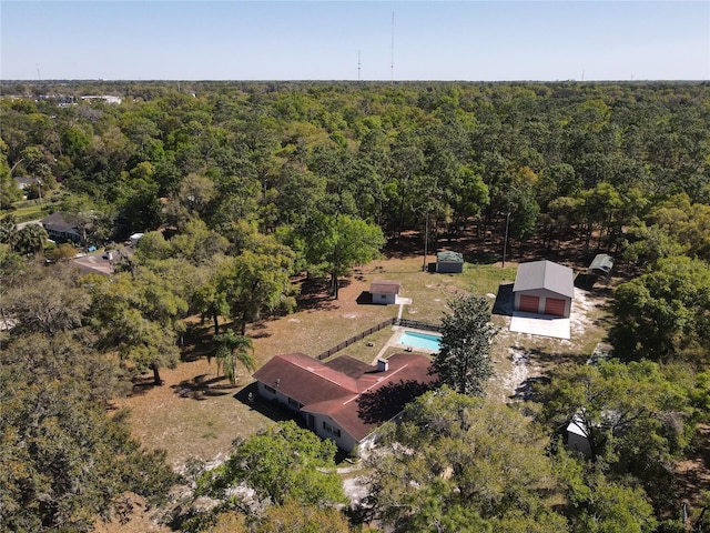 birds eye view of property with a forest view