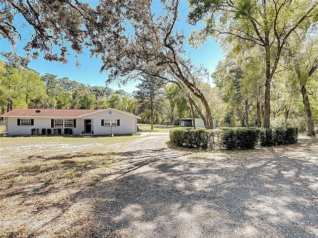 view of street with gravel driveway