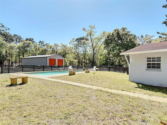 view of yard featuring an outdoor structure and fence