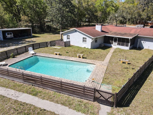 view of swimming pool with a yard, fence private yard, a fenced in pool, and a sunroom