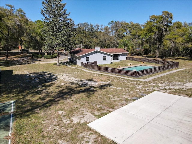 exterior space featuring a fenced in pool, a yard, and fence