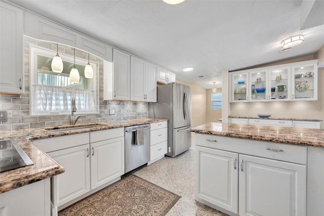 kitchen featuring a sink, light speckled floor, appliances with stainless steel finishes, and white cabinetry