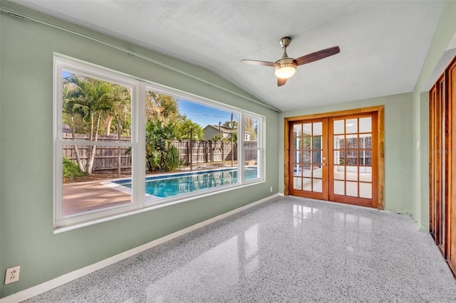 unfurnished sunroom featuring lofted ceiling, french doors, and ceiling fan