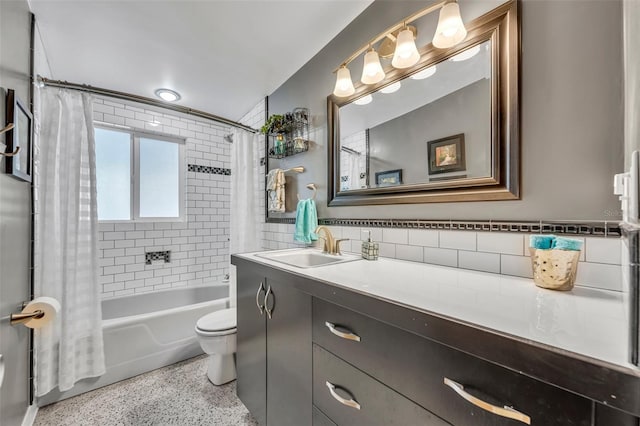 full bath with shower / bath combo with shower curtain, toilet, tile walls, speckled floor, and vanity