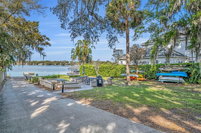 surrounding community featuring a yard and a water view