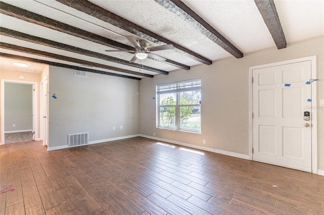 interior space with visible vents, beamed ceiling, wood finished floors, baseboards, and ceiling fan