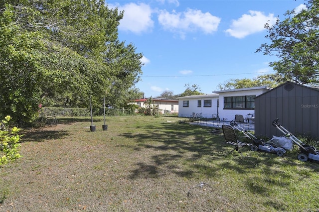 view of yard with a storage unit and an outbuilding