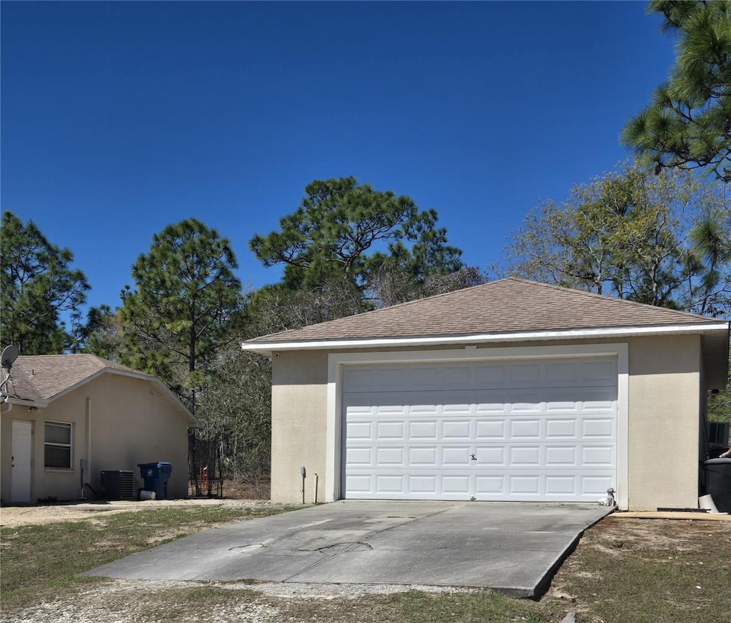 detached garage featuring central AC