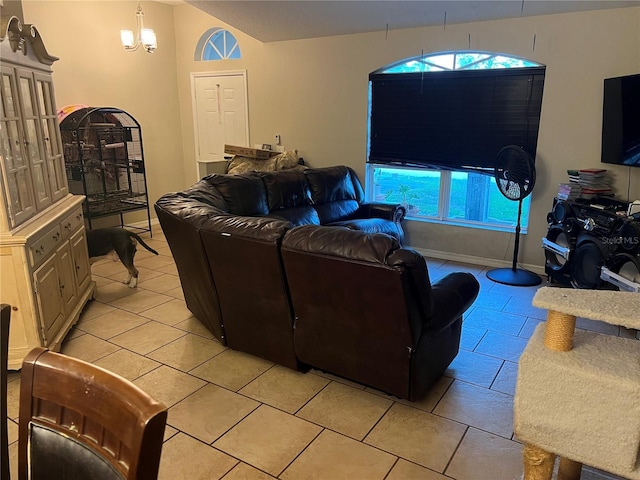 living room with vaulted ceiling, light tile patterned flooring, and plenty of natural light