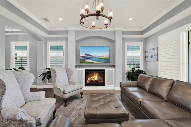 living area featuring baseboards, visible vents, recessed lighting, a warm lit fireplace, and ornamental molding