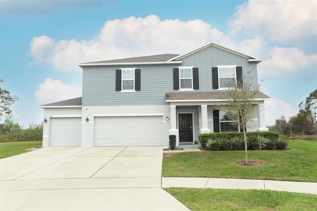 traditional-style home with a front yard, concrete driveway, board and batten siding, and an attached garage