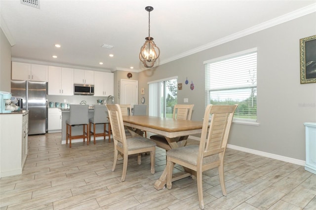 dining space featuring visible vents, ornamental molding, an inviting chandelier, baseboards, and wood tiled floor