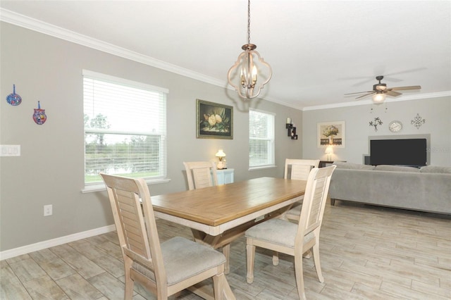 dining space with light wood-type flooring, baseboards, crown molding, and ceiling fan with notable chandelier