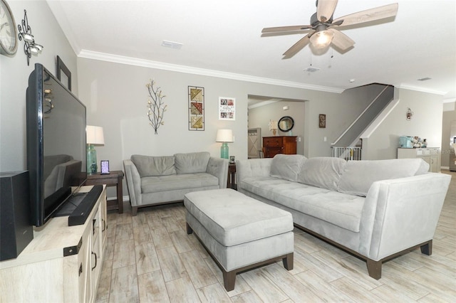 living room with stairs, crown molding, visible vents, and wood finish floors