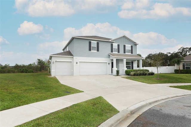 traditional-style home featuring a front lawn, fence, concrete driveway, a shingled roof, and a garage