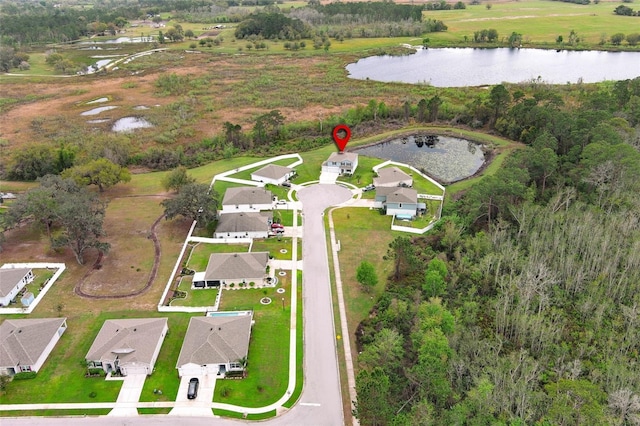 drone / aerial view with a residential view and a water view