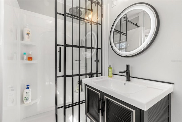 bathroom with vanity and a shower