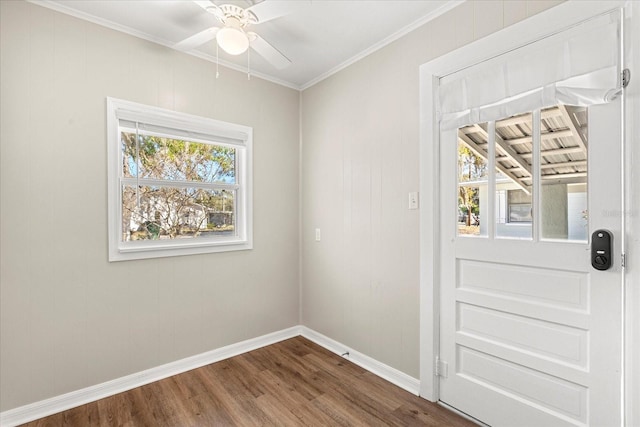 doorway to outside with baseboards, dark wood-type flooring, a healthy amount of sunlight, and ornamental molding