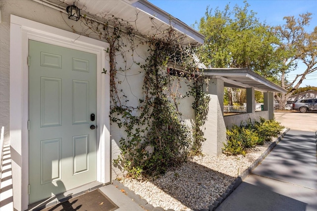 view of exterior entry with stucco siding