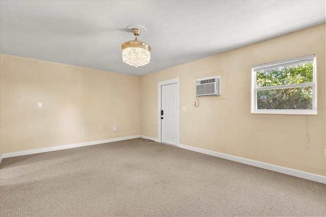 carpeted empty room featuring a wall mounted AC and baseboards