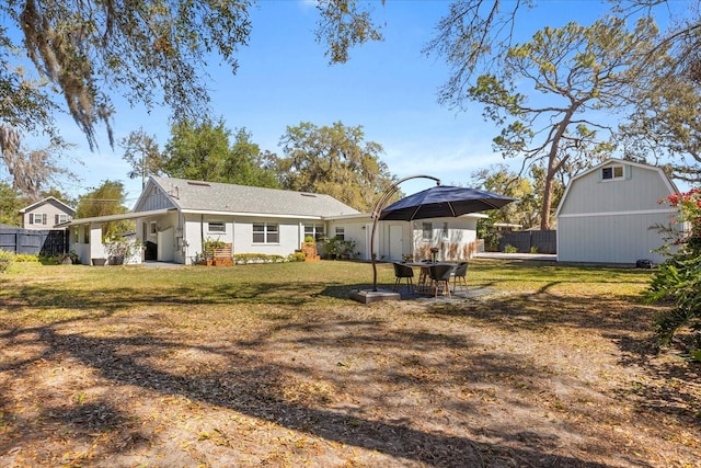 view of yard with an outdoor structure and fence