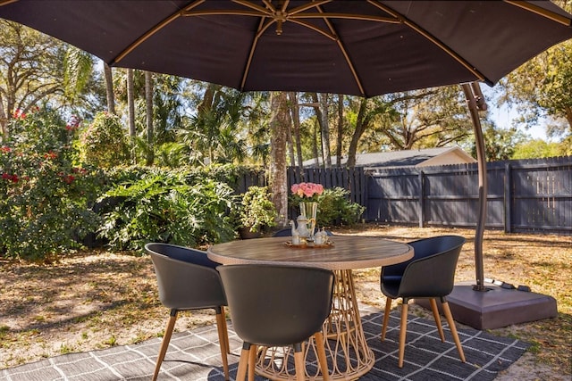 view of patio / terrace featuring outdoor dining space and fence