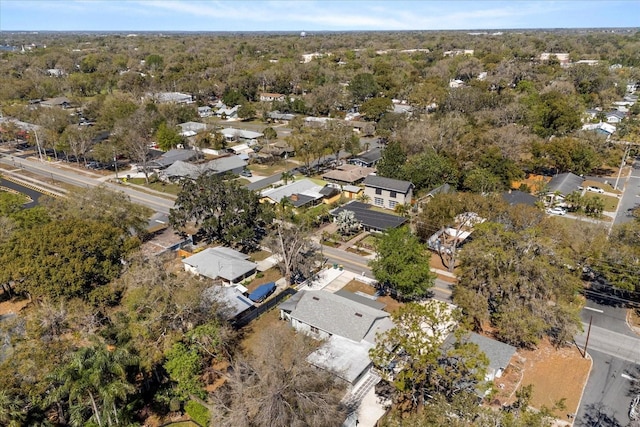 drone / aerial view with a residential view and a view of trees