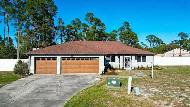 single story home featuring fence, driveway, stucco siding, a front lawn, and a garage