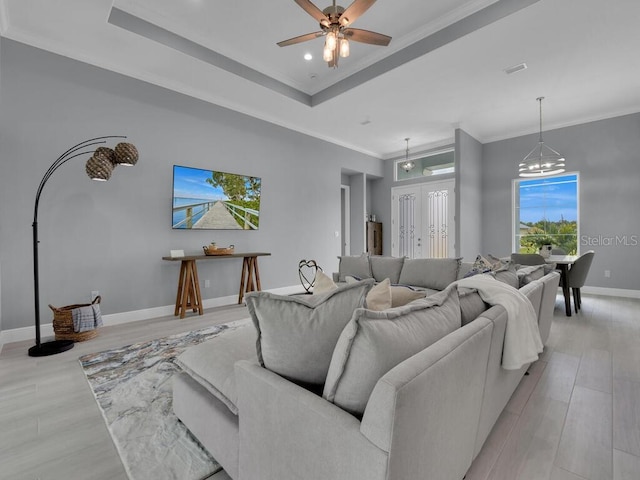 291 Rotonda Blvd S, Rotonda West, FL 33947 - living area with ornamental molding, light wood-style flooring, a raised ceiling, a ceiling fan, and a chandelier