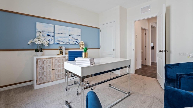 carpeted office space with baseboards and visible vents