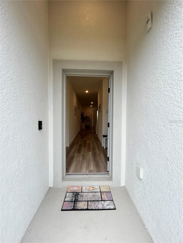 view of exterior entry with stucco siding